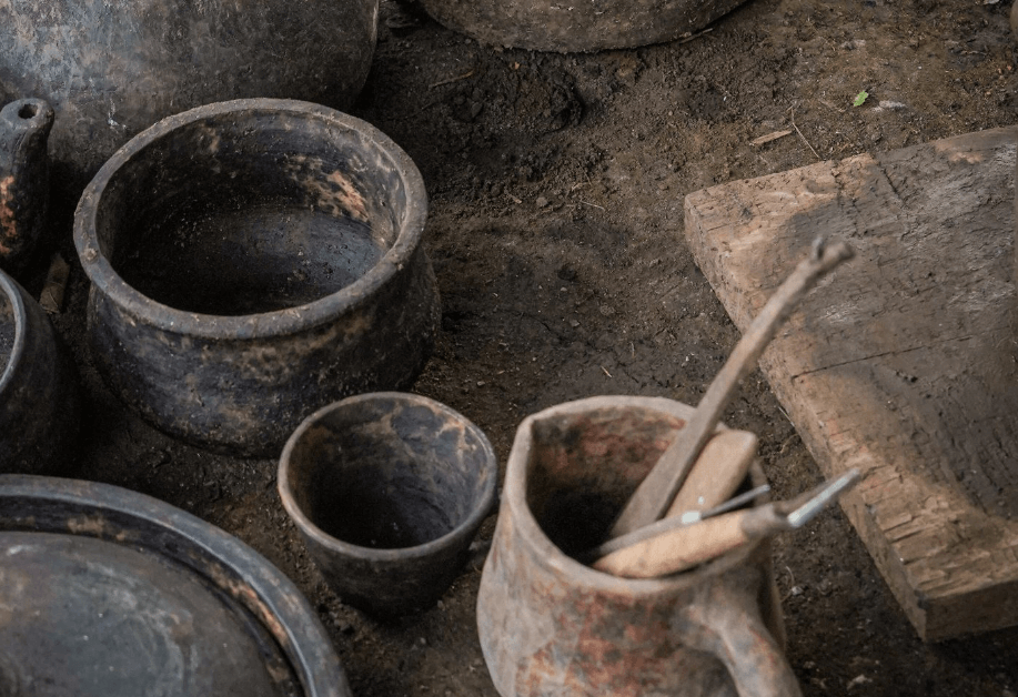 A group of clay pots and utensils
Description automatically generated