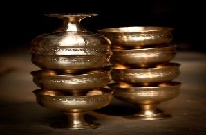 A close-up of several gold bowls
Description automatically generated